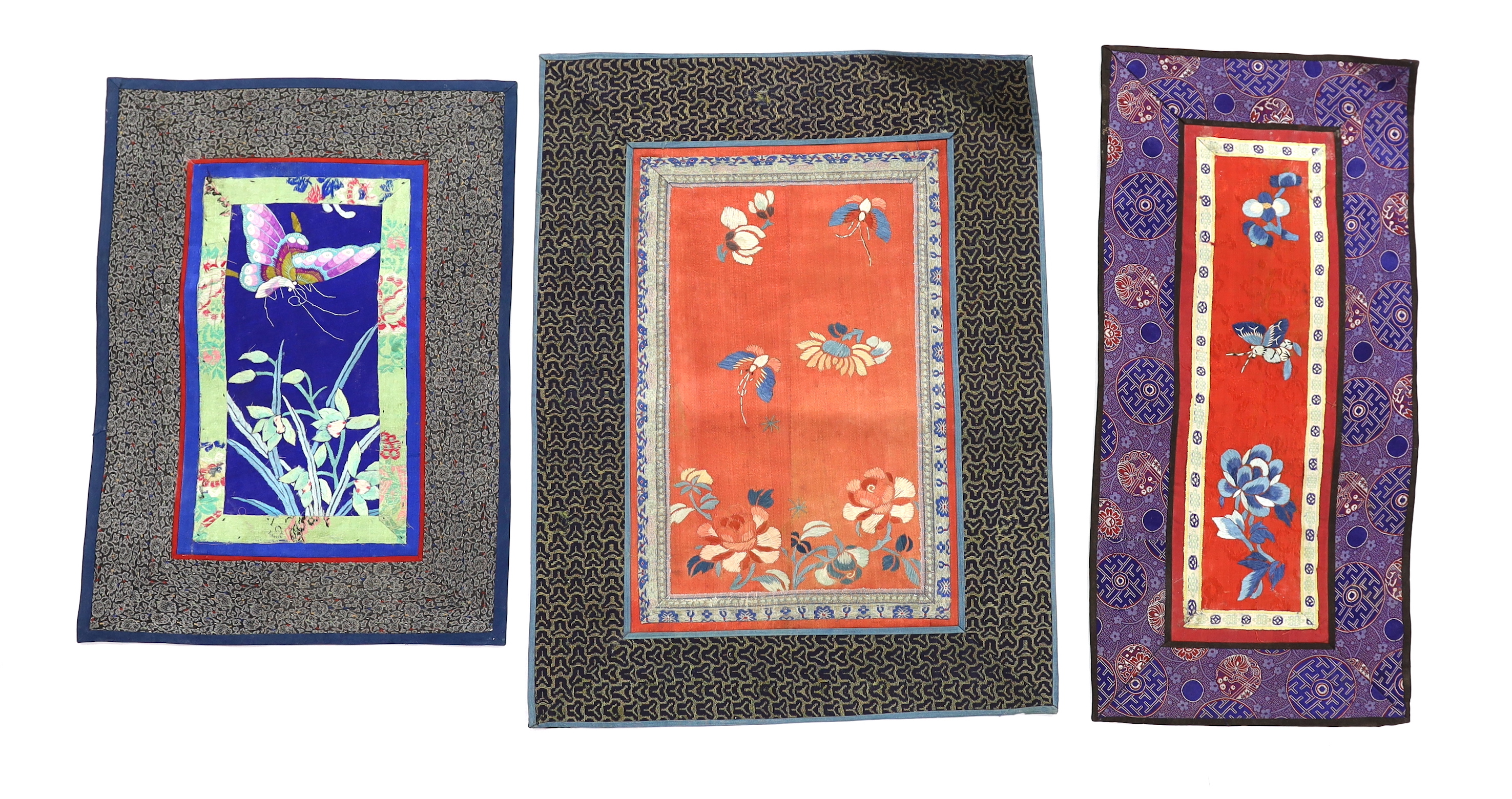 Twelve various Chinese rectangular silk polychrome embroidered mats with damask borders, of varying sizes